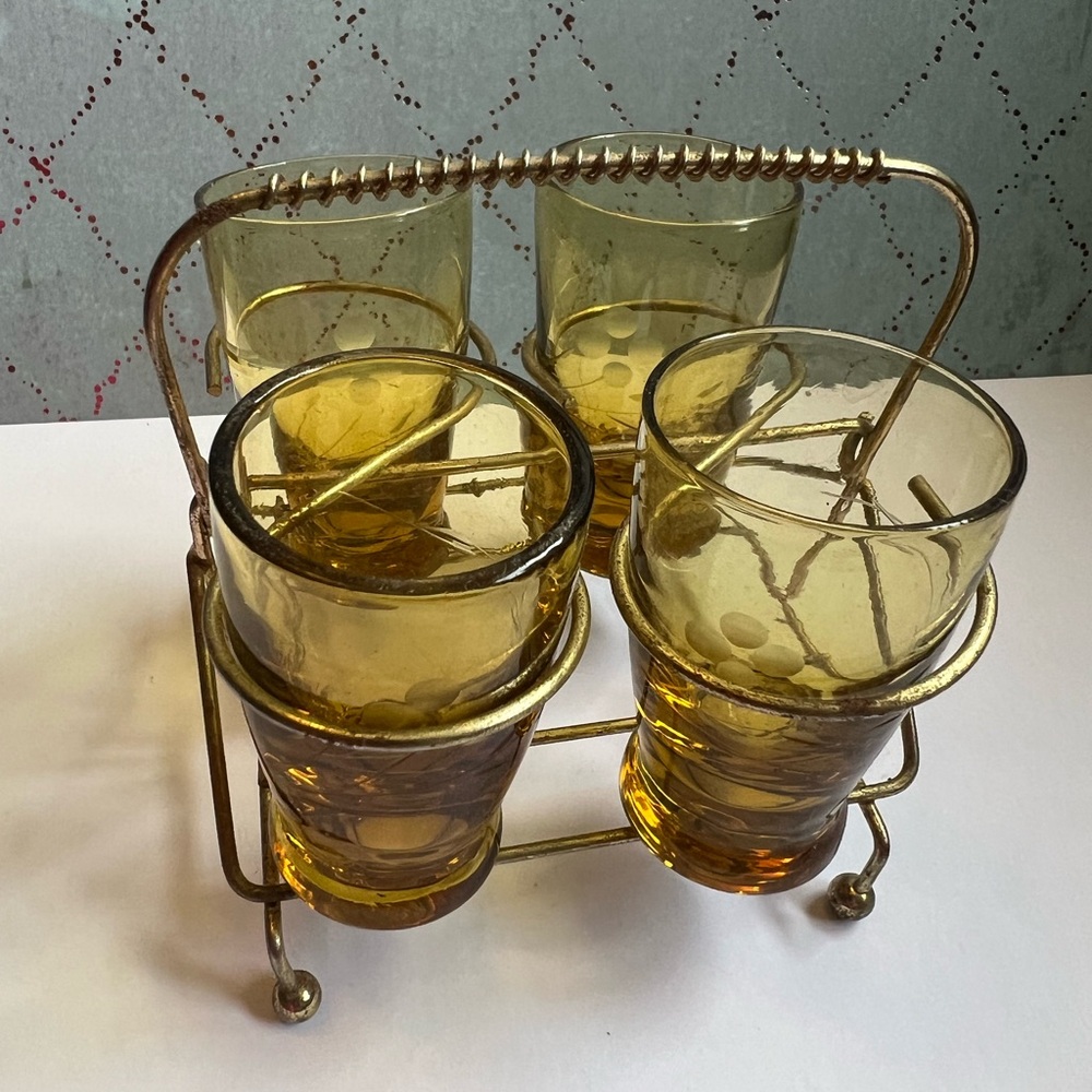 Vintage shot glasses in brass stand